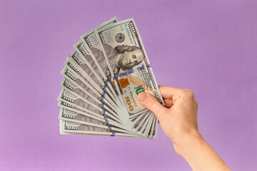 Dollars in hands on а purple background