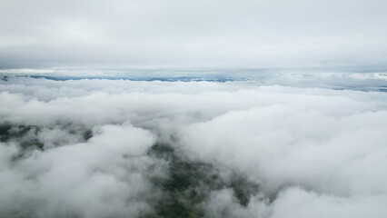 Obraz premium Aerial view above the white sea of clouds over the valley, natural view.