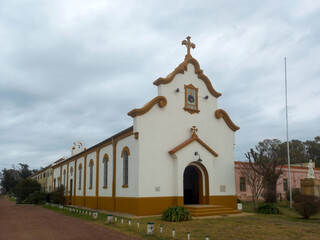 Fototapeta na wymiar colonial facade of the chapel of the Salesian Agrotechnical School Don Bosco. Uribelarrea, Argentina