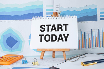 Text start today on paper card and calculator on wooden background