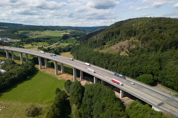 aerial view of a autobahn bridge going over the valley in the countryside