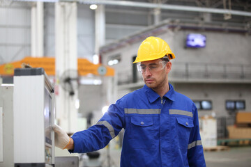 worker or engineer working in factory with safety uniform , safety hat and safety glasses , image is safety concept or happy workplace