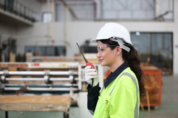 worker or engineer working in factory with safety uniform , safety hat and safety glasses , image is safety concept or happy workplace