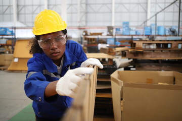 worker or engineer working in factory with safety uniform , safety hat and safety glasses , image is safety concept or happy workplace