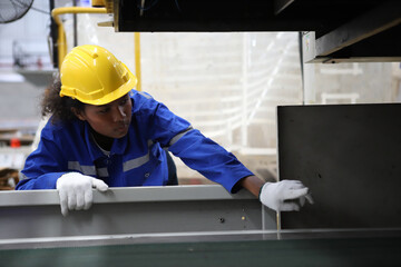 worker or engineer working in factory with safety uniform , safety hat and safety glasses , image is safety concept or happy workplace