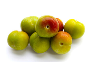 Fresh green plum on white background
