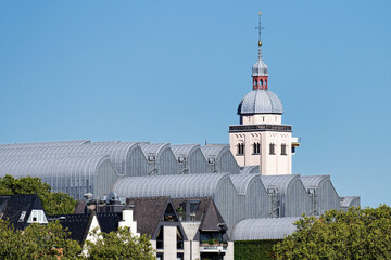 the elegant waves of the Museum Ludwig in cologne's old town in front of the church tower of the...