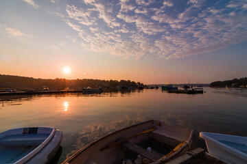 Round Pond Harbor, Maine, USA, boats in the harbor on a quiet still morning at sunrise in summer