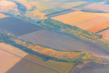 Aerial view of agricultural fields and meadows . Plowed lands view from above
