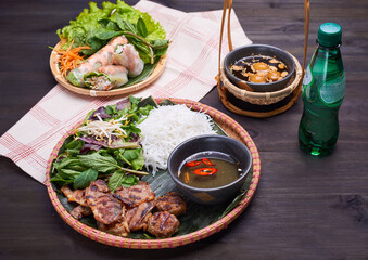 Vietnamese dish set with spring rolls on the dark table