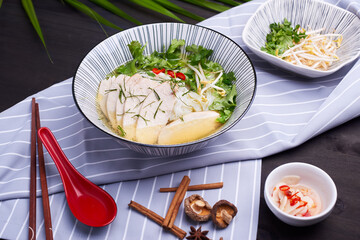 Pan-Asian dish setup on the dark table