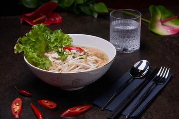 Asian soup. Vietnamese cuisine composition on a dark table