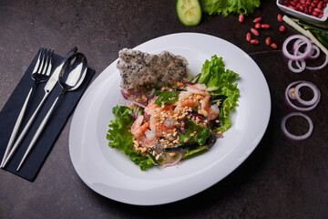 Shrimp bowl. Pan-asian dish top view on a dark table