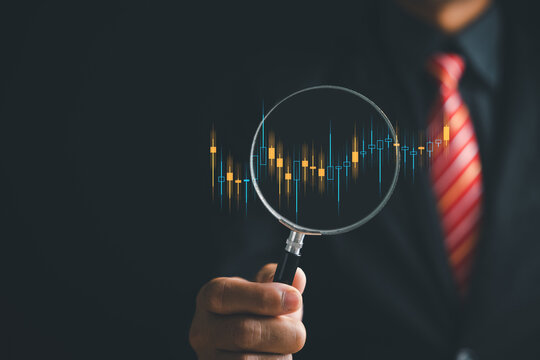 With a keen eye for opportunity, a trader harnesses the magnifying glass to focus on the bar graph's increasing arrow, decoding market trends and optimizing business investment strategies.