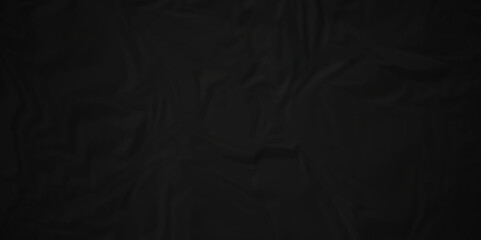 Black silk crumpled paper texture dark black crumpled paper texture crush paper so that it becomes creased and wrinkled. Old black crumpled paper sheet background texture.