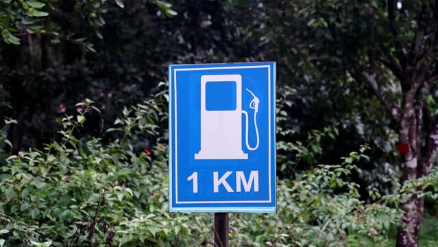 Gasoline station 1 kilometer ahead signpost