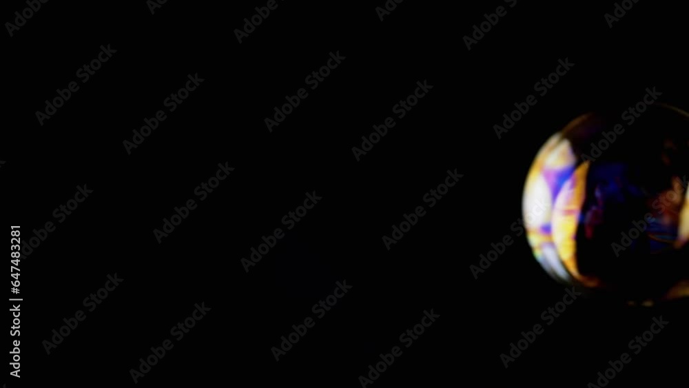 Poster lot of large colorful soap bubbles fly on a black background in empty space. close up. vibrating tra