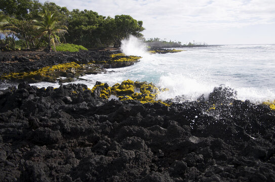 Waves Crash Into The Shore At Isaac Hale Park On The Big Island Of Hawaii; Island Of Hawaii, Hawaii, United States Of America