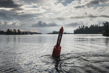 Red Buoy In A Lake With Letters And Numbers; Ontario, Canada