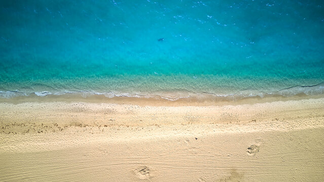 Aerial above photo of sandy beach and ocean with waves