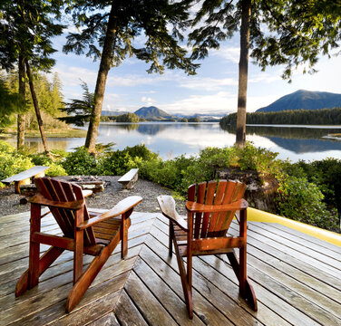 Wooden Adirondack Chairs On A Deck Overlooking The Water, Tofino Chalet On Jensen's Bay; Tofino, British Columbia, Canada