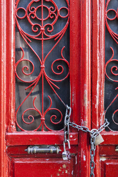 Red Door With Decorative Windows Chained Shut With A Padlock; Athens, Greeec