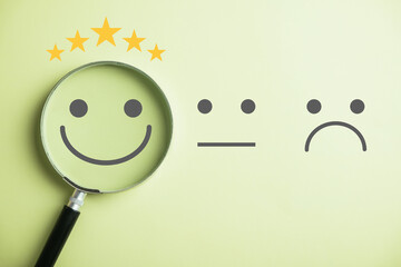 Discovering happiness smiley face in magnifying glass conquering sadness. Customer satisfaction and...