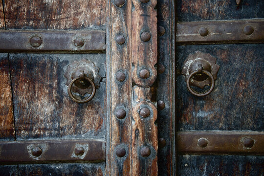 Close Up Of Old Wooden Door With Brass Rings; Dharpatha Mal, Madhya Pradesh, India