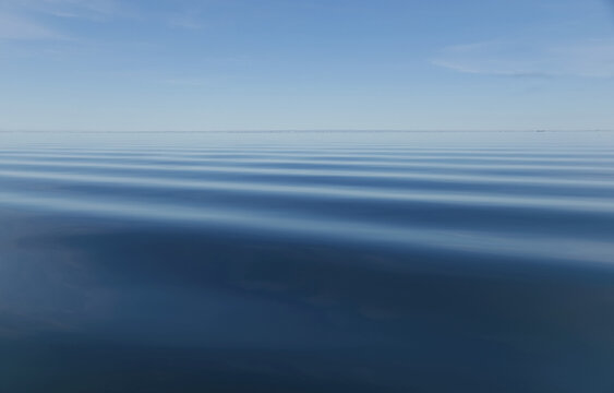 Surface Of Blue Water With Slight Ripples And Blue Sky With Horizon In The Distance