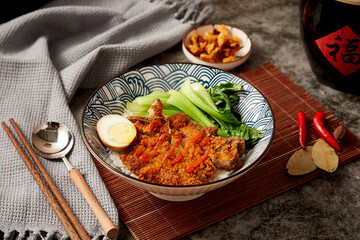 Pork chop noodles, shot indoors on a tabletop (translation of the word 