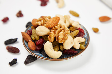 mixed nuts in bowl,Nut foods, various mixed nuts, raisins, walnuts, almonds, black rice, peanuts, milk, vitamin supplement foods
