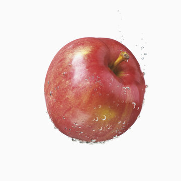 A Red Apple Covered In Water Droplets On A White Background; Toronto, Ontario, Canada