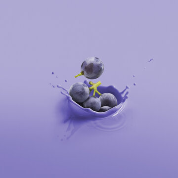 Cluster Of Blueberries Splashing Into A Blue Liquid; Toronto, Ontario, Canada
