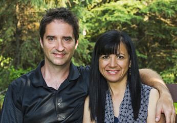 Portrait Of A Mature Couple Outdoors On A Bench In Autumn; Sherwood Park, Alberta, Canada