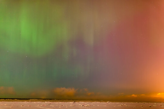 The northern lights dance in the night sky above knik arm in this view from the tony knowles coastal trail in winter; Anchorage alaska united states of america