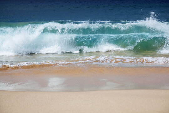 Hawaii, Maui, Makena, Crystal Clear Ocean Wave Crashing On A White Sandy Beach.