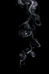 Abstract white smoke swirls on black background.