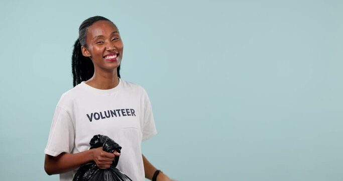 Plastic bag, volunteer and happy black woman point at pollution cleaning checklist, community service timeline and NGO. Mockup studio space, waste project plan and portrait person on blue background