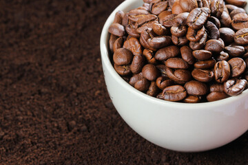 Coffee beans in coffee cup isolated on white