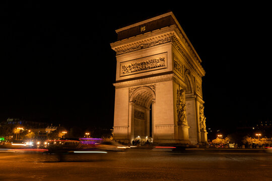 Iconic Arc de Triomphe illuminated at night in Paris; Paris, France