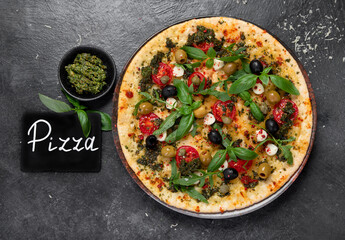 Delicious pizza with cherry tomatoes and fresh basil.
