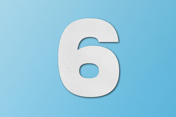 White paper font number 6 isolated on light blue background.