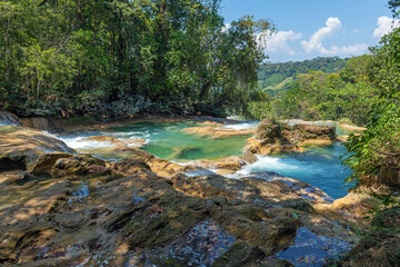 Naklejka na ściany i meble Agua Azul cascades with tropical rainforest and turquoise waters near Palenque, Chiapas, Mexico.