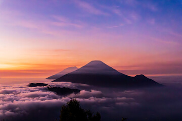 The beautiful view of the sunrise with Mount Sindoro, Mount Sumbing, and Mount Kembang as well as the sea of ​​clouds between the two is a truly amazing sight.