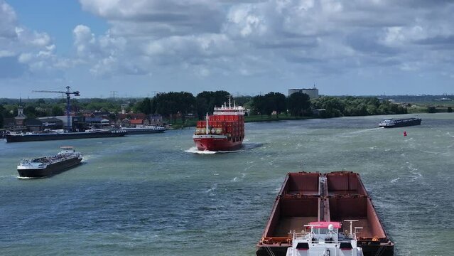 moving empty garbage scow and cargo ship on the river in Zwijndrecht, aerial tracking