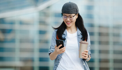 People use mobile phone walking with coffee cup in hand