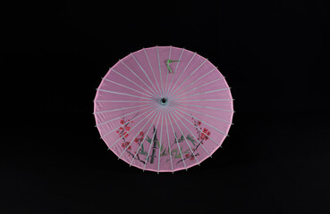 chinese paper umbrella on black background