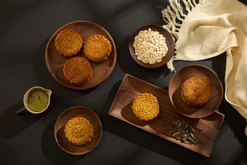Chinese Mid-Autumn Festival concept made from mooncakes on wooden trays. Mid-Autumn Festival is a long-standing meaningful custom not only in Vietnam and China but also in other countries in Asia.
