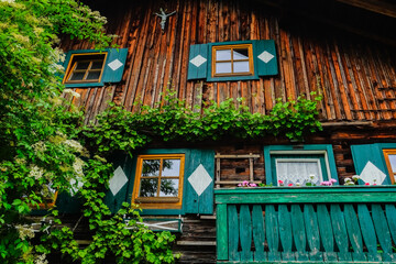 old colorful house with wood and flowers during hiking in salzburg