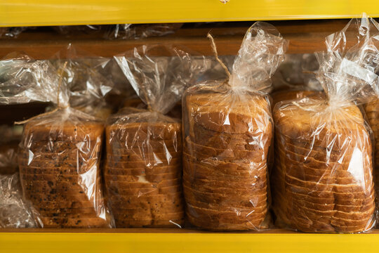 Fresh bread counter. Delicious loaves of bread in plastic in a baker shop.